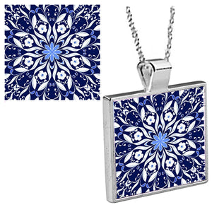 "Blue Delft Kaleidoscope"  is an original Kathryn Rutherford work of graphic art reproduced as a silver bezel pendant with 18 inch silver plated chain with bale clasp.  Original graphic art design is dye sublimation printed on high gloss aluminum set inside a silver plated bezel.