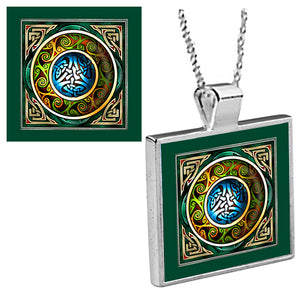 "Blue and Green Shield Medallion"  is an original Kathryn Rutherford work of graphic art reproduced as a silver bezel pendant with 18 inch silver plated chain with bale clasp.  Original graphic art image is dye sublimation printed on high gloss aluminum set inside a silver plated bezel.