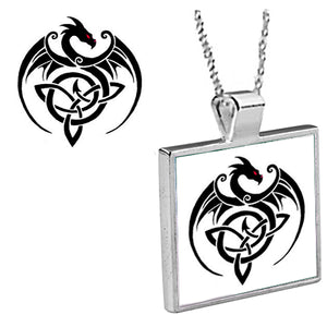 "Black Dragon Tattoo"  is an original Kathryn Rutherford work of graphic art reproduced as a silver plated bezel pendant with 18 inch silver plated chain with bale clasp, original fine art graphic is dye sublimation printed on high gloss aluminum set inside a silver plated bezel.