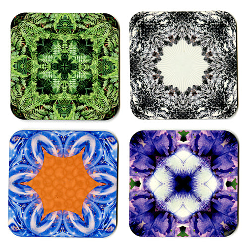 Photographic Kaleidoscope Rubber Backed Set of Coasters displaying original Kathryn Rutherford manipulated photographs of green ferns, snow on evergreen tree, soap bubbles, and purple iris. 